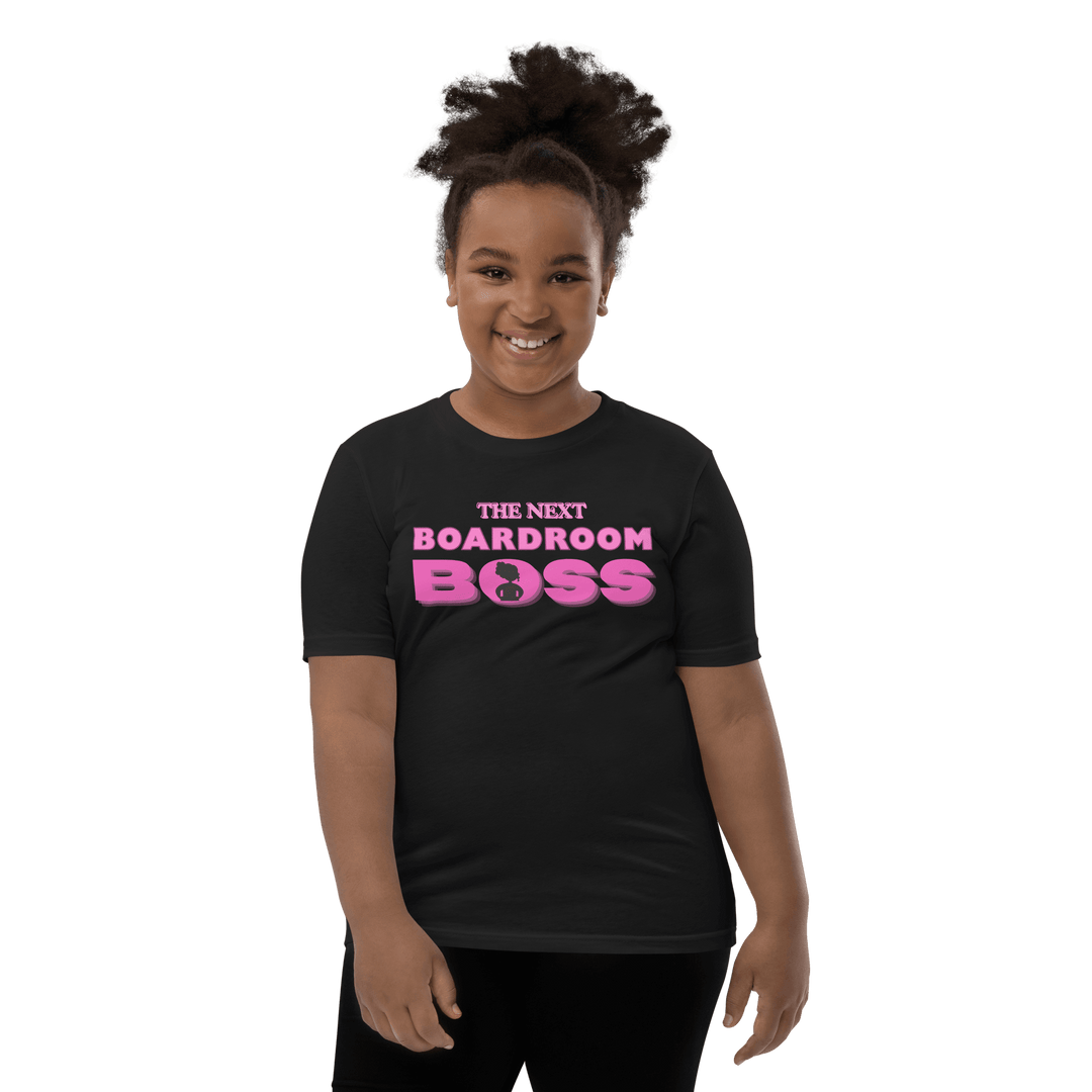 Young Black girl smiling in Pink and black The Next Boardroom Boss T-shirt from TL Johnson’s Mini Monarchs line; empowerment apparel for future leaders.