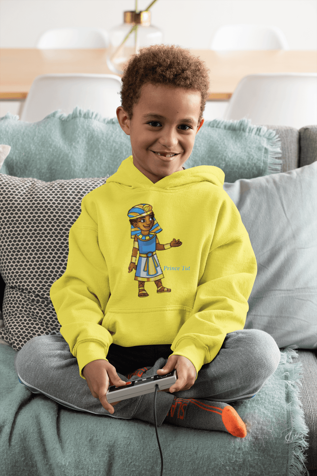 Tut hoodie from TL Johnson Stories featuring crown emblem and character name; cultural empowerment fashion for all ages.