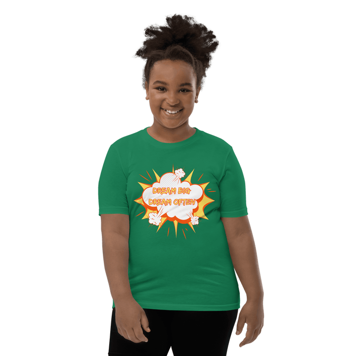 Young Black girl wearing Green Dream Big T-shirt inspired by TL Johnson’s Dream Big Coloring Book: Careers in Black Excellence; empowerment apparel celebrating career goals.