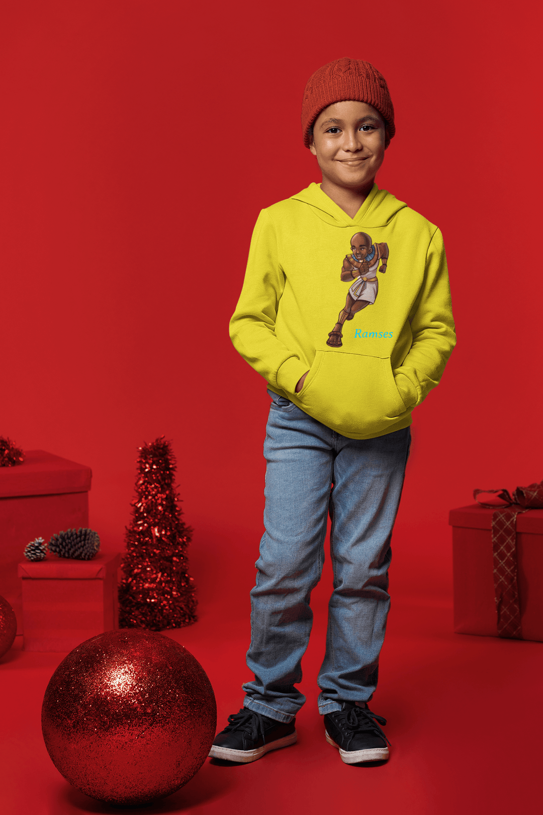 Boy wearing Ramses hoodie representing strength and wisdom from TL Johnson Stories. Sorrounded by Christmas Items
